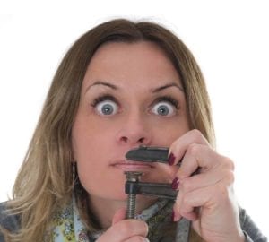 Woman holding a clamp over her lips" don't give too much information.