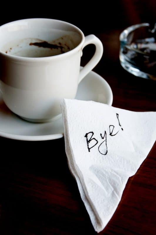 Napkin with the word "Bye!" on it next to coffee cup. Divorce after a trial separation.