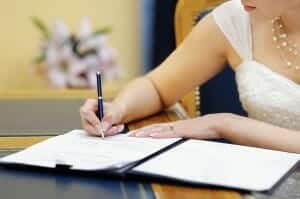 Bride signing an agreement before the wedding.