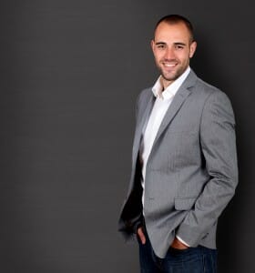 Man in blue jeans, but with crisp white shirt and business jacket.