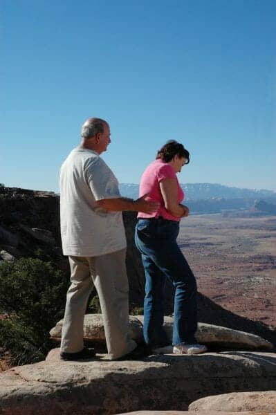 Upset/arguing senior couple on a mountain with a desert background.