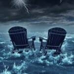 Two empty lawn chairs in a storm