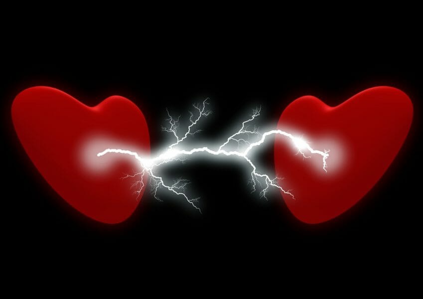 Two red hearts with lightning/electricity between them. Symbolic for how to talk to your ex.