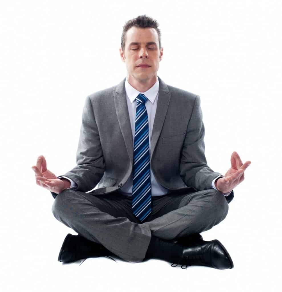 Business man sitting in lotus position, meditating.