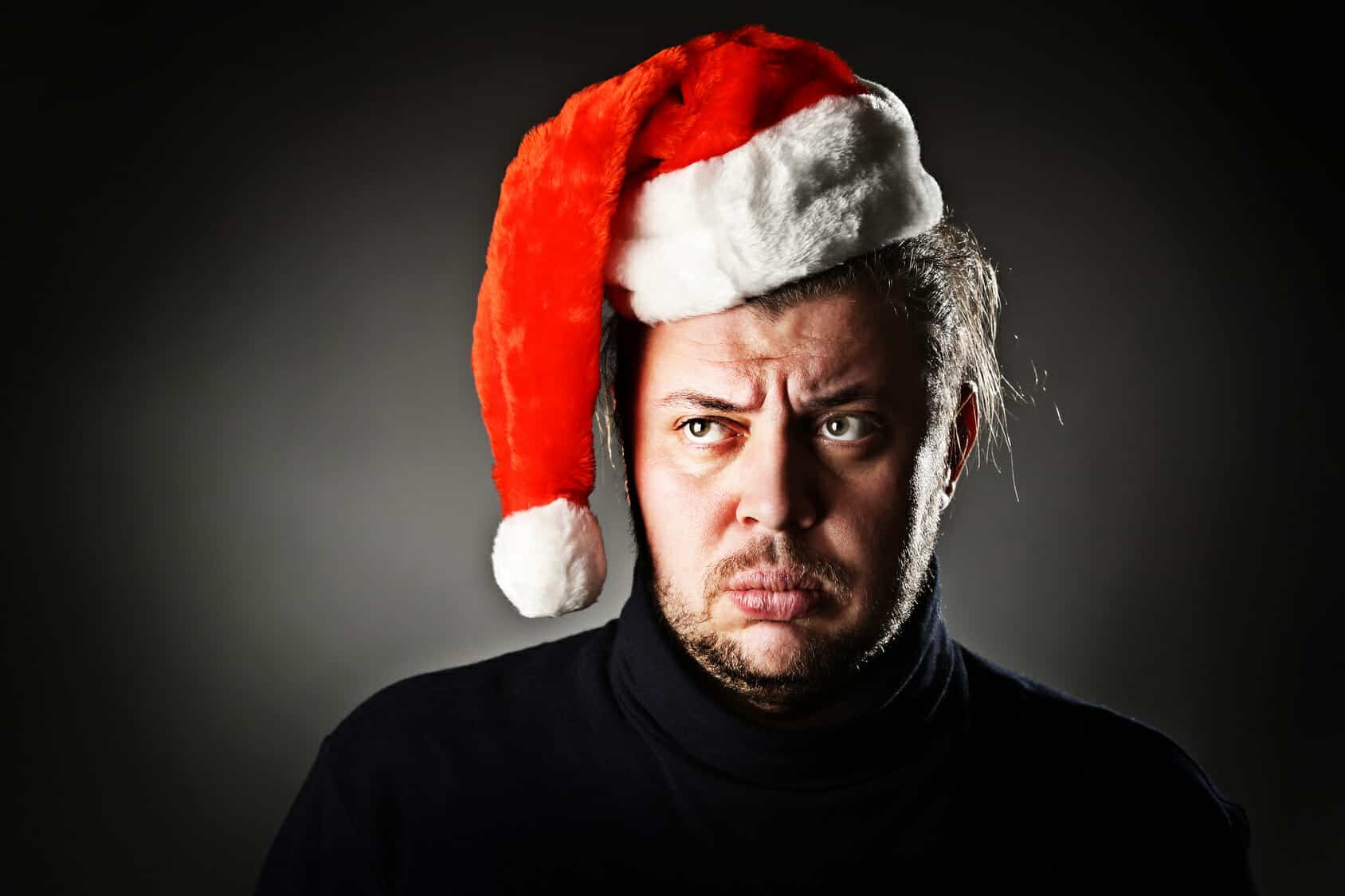 Upset man wearing a Santa Hat is getting a divorce during the holidays