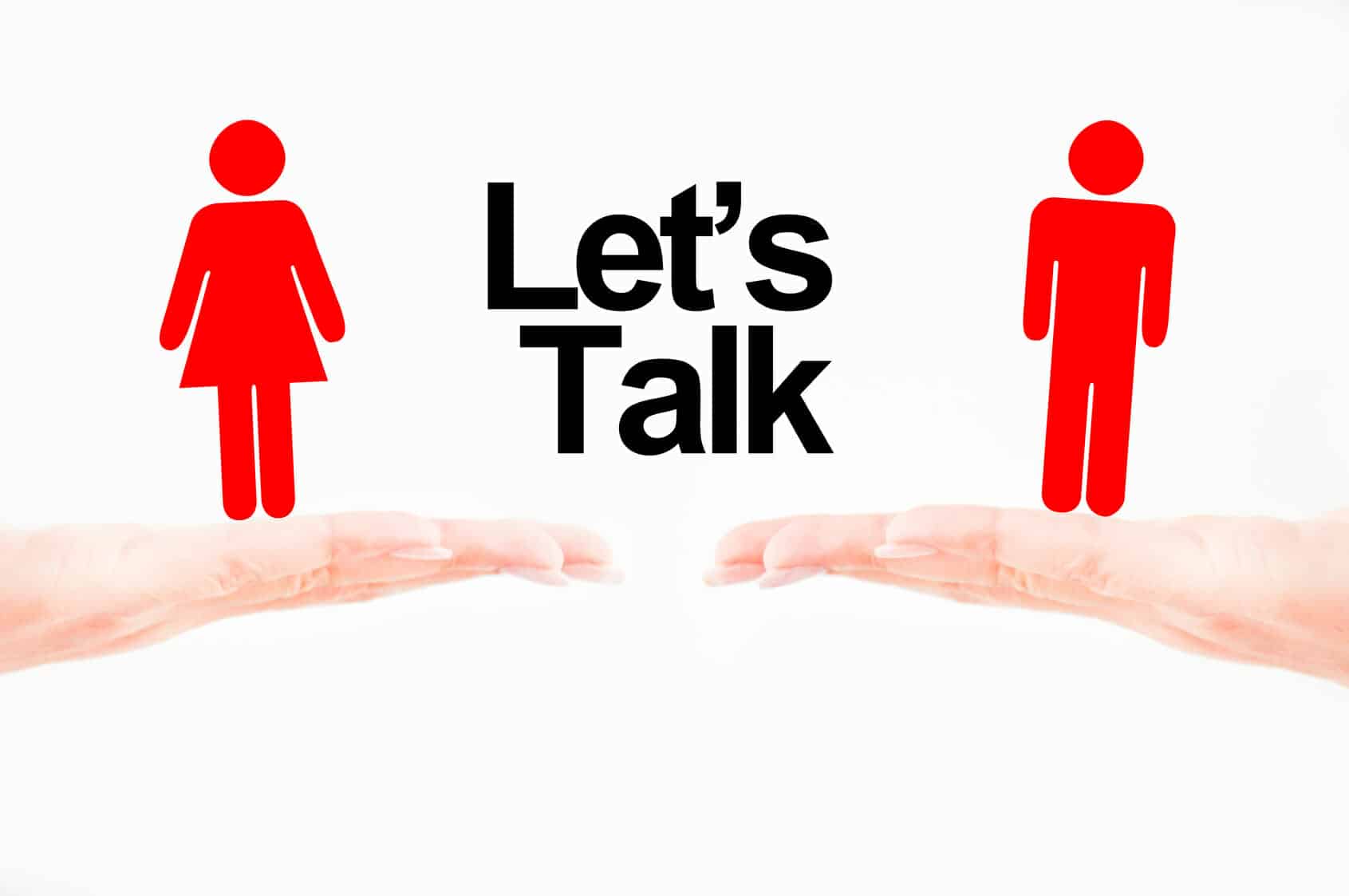 Hands holding red figures of a man and a woman with the words "Let's talk" between them.