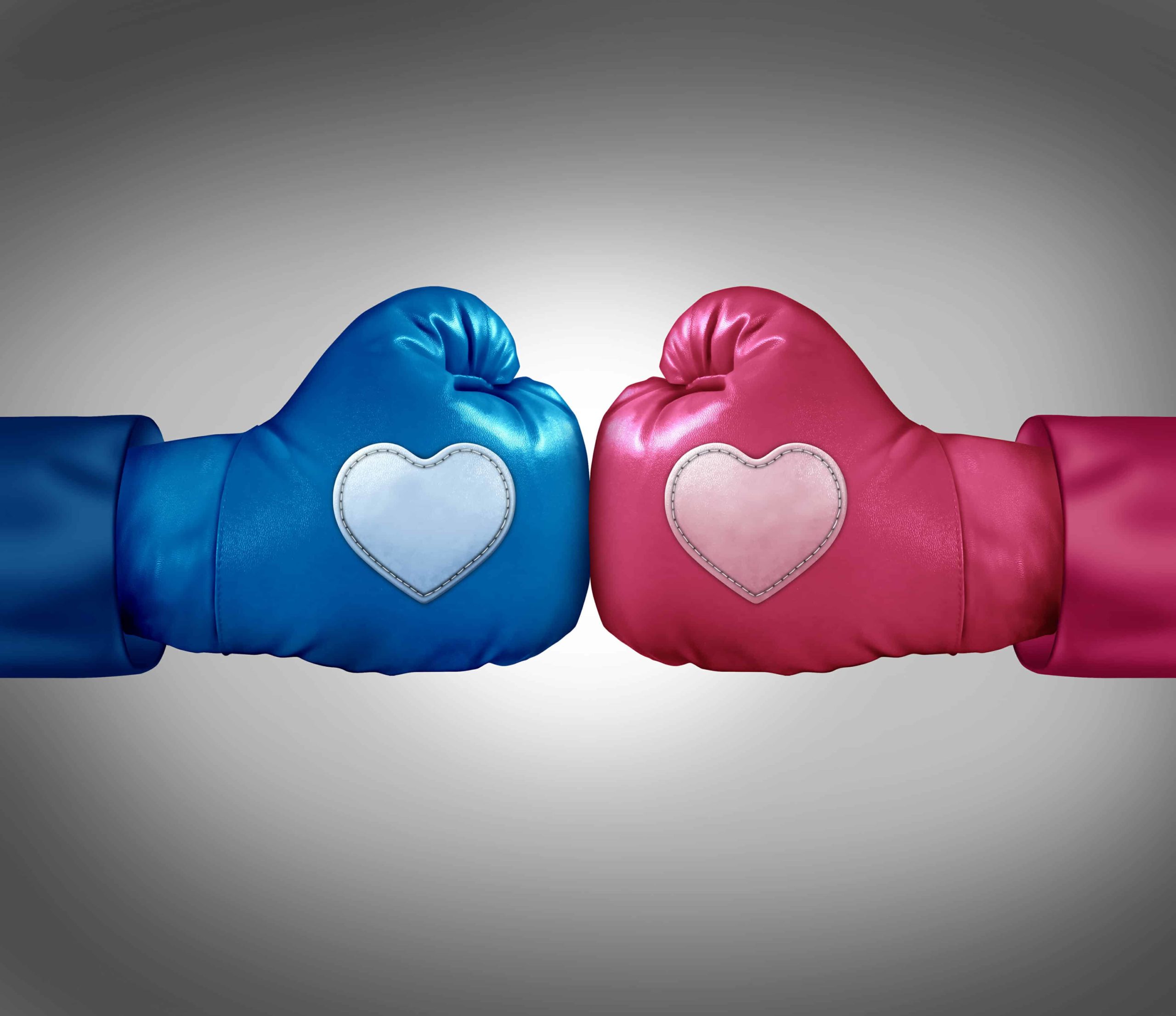 Blue and pink boxing gloves with hearts on them facing off.