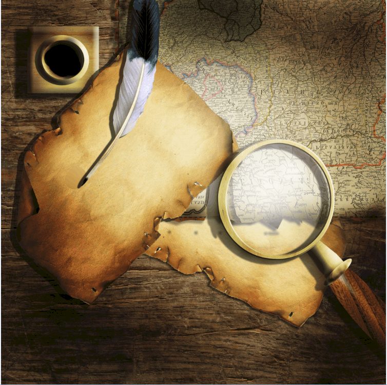 Old map with quill and magnifying glass on a wooden desk.