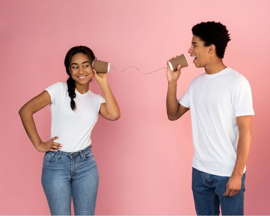 couple talking on string phone couple talking on a tin can phone with a string