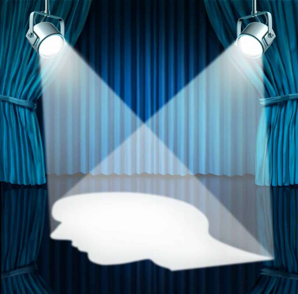 Spotlights on stage forming a picture of a white head.