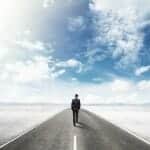 Take the high road in divorce - Business man walking on road in the clouds