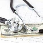 Health Insurance - stethoscope on stack of money