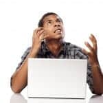 Frustrated African american man at a laptop