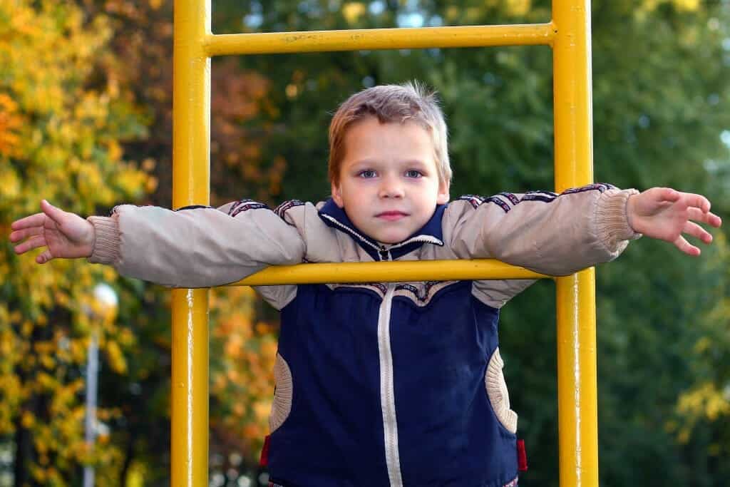 Young boy on climbing bars