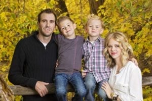Fall picture of family where parents look like they are faking smiles