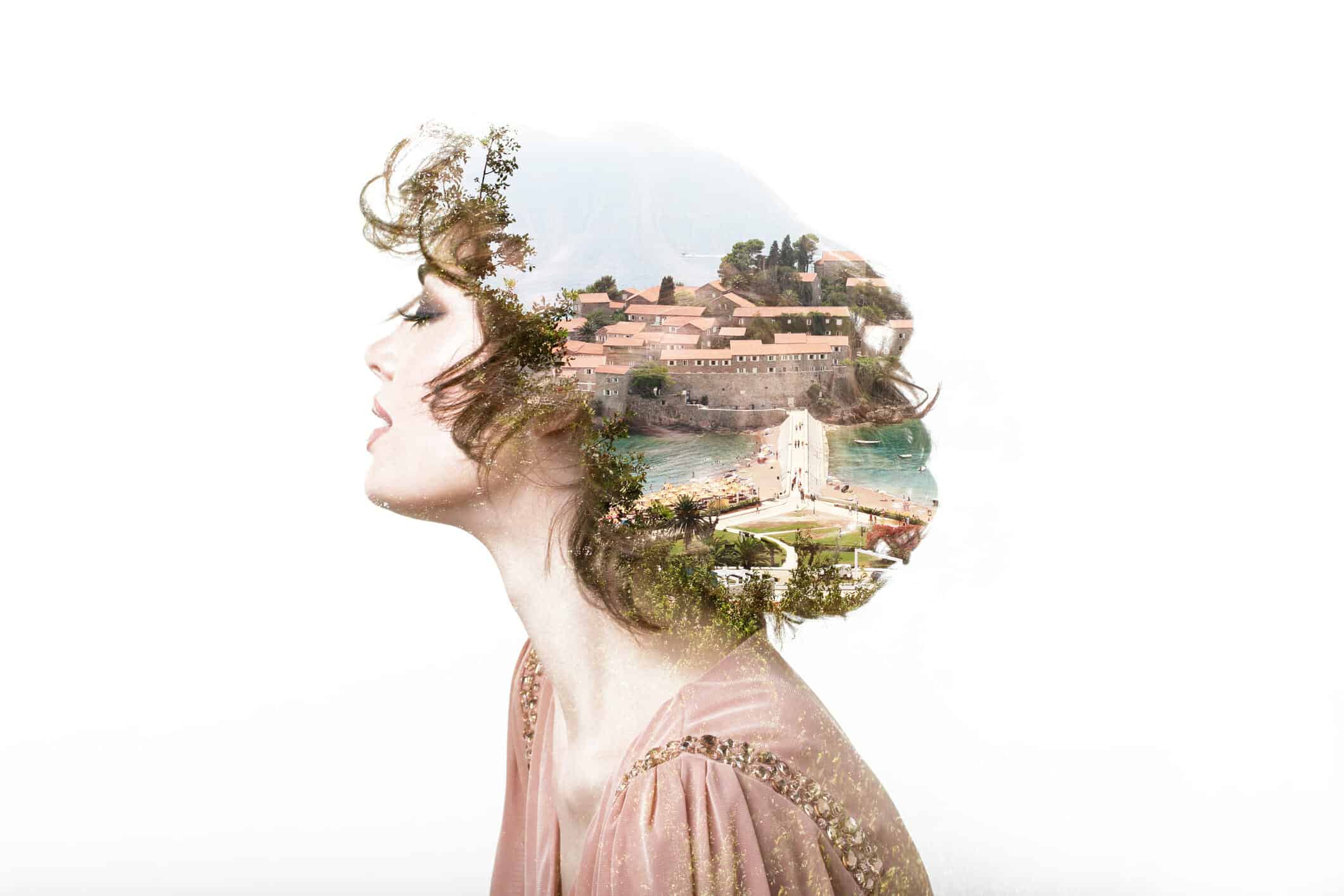 Woman with her eyes closed and a picture of her dream home superimposed in her hair.