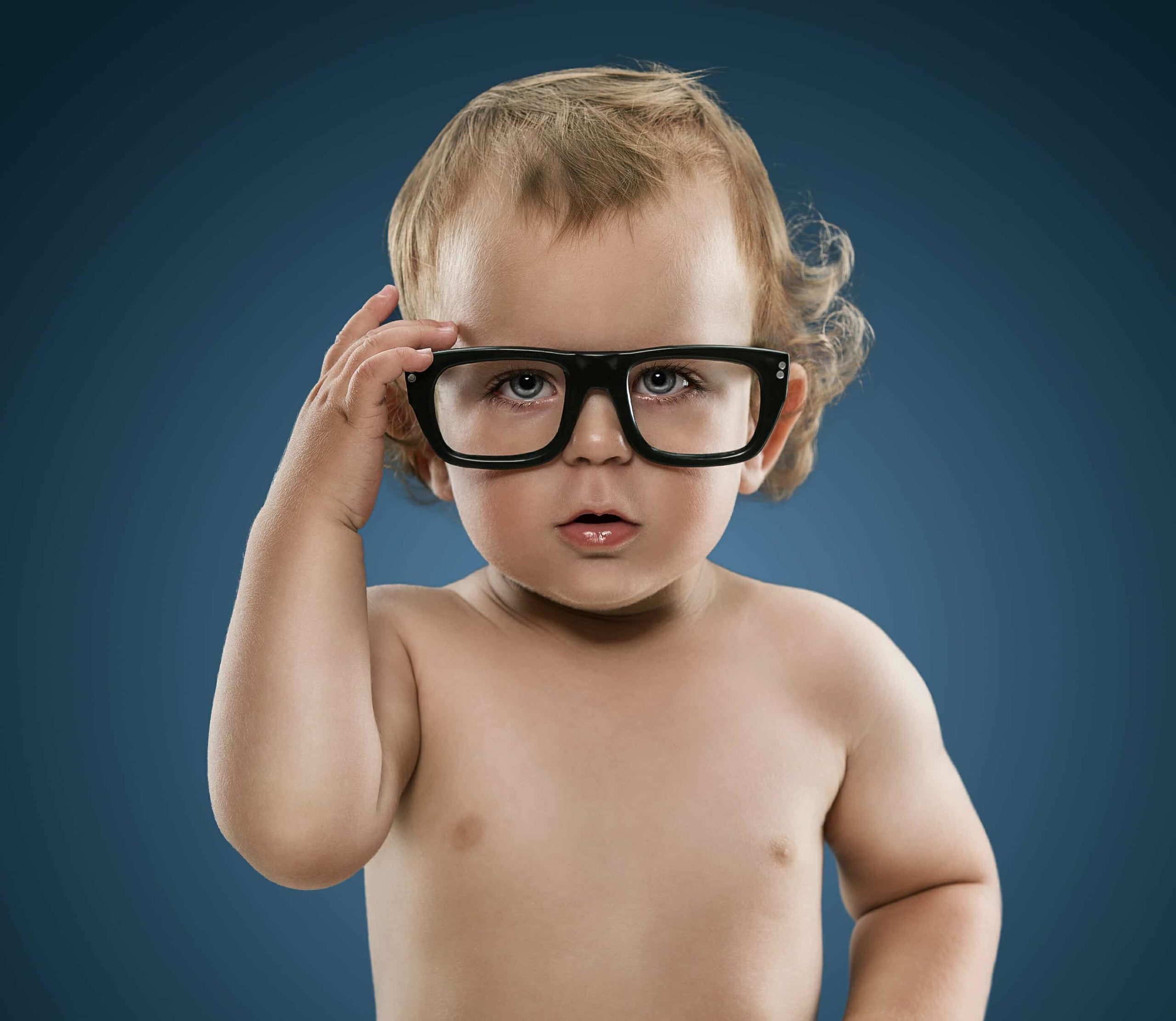 Cute little nerd boy wearing glasses isolation on blue background