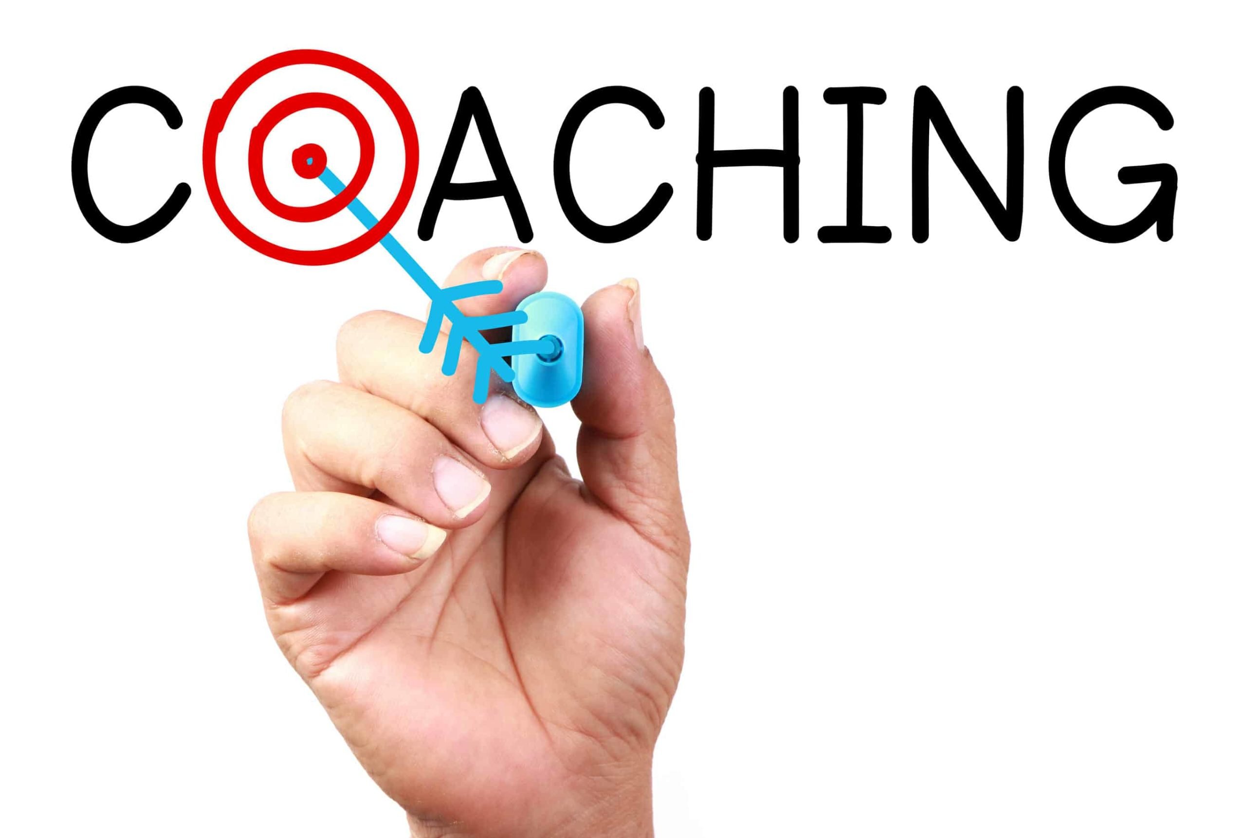 Hand drawing an arrow in the word "Coaching" with a target in the "O."