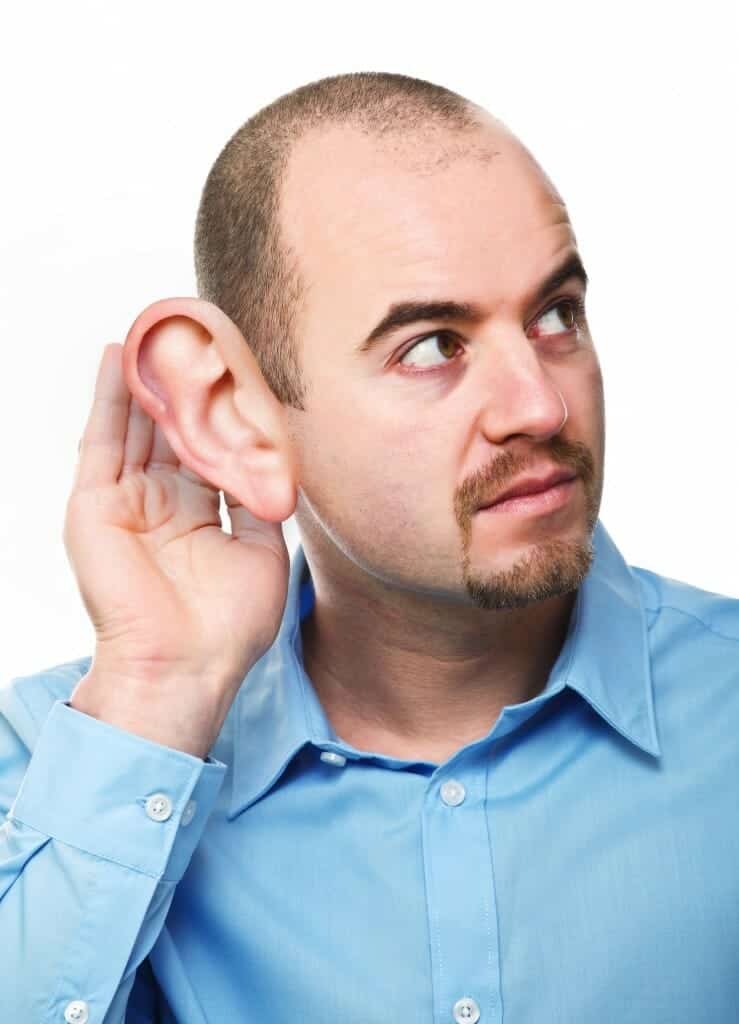 Man with hand next to his oversized ear - listening