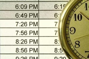 Clock next to schedule of times.