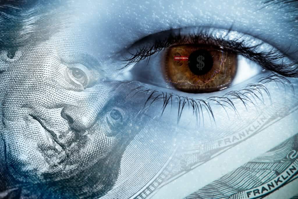 Close up of an eye with a picture of a dollar bill superimposed on it signifying divorce financial issues.