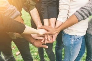 Multiracial Group of Friends with Hands in Stack, support gorup.