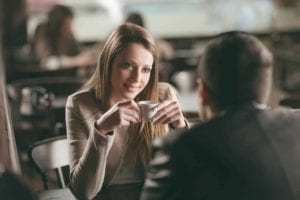 Dating scene of man and woman having coffee.