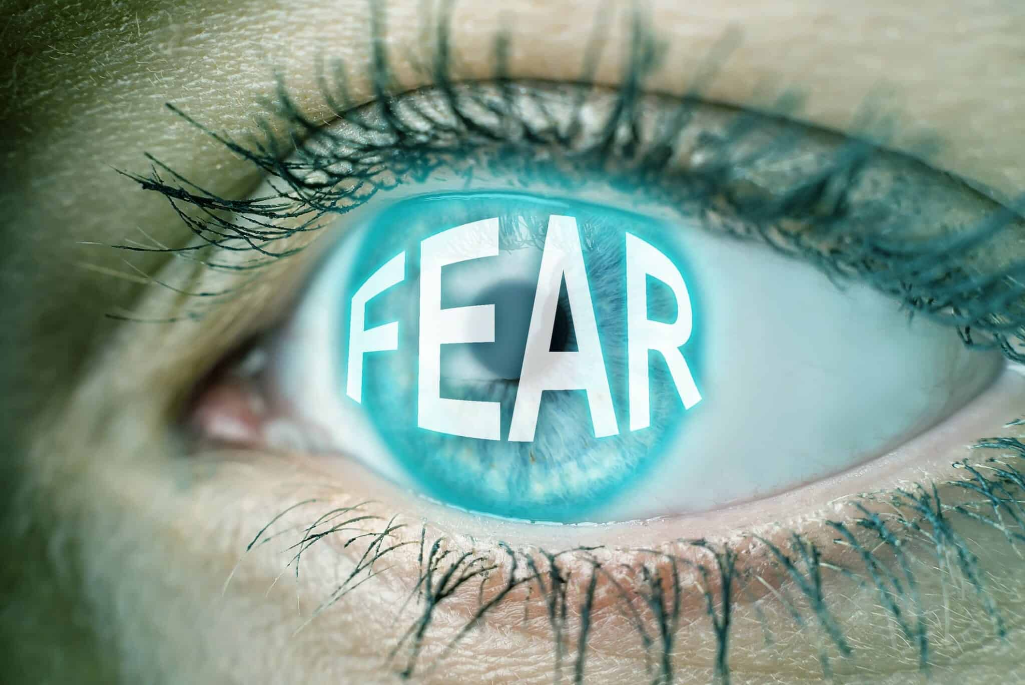 Close up of eyeball with the word "Fear" on it: Fear of Divorce