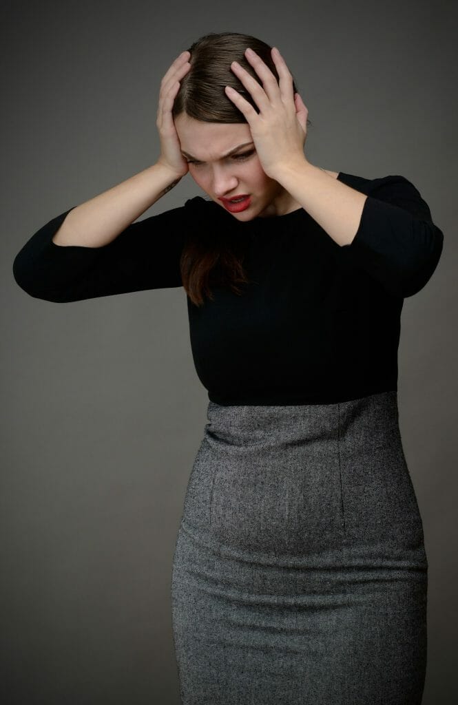 Upset woman holding her head: Don't take it personally