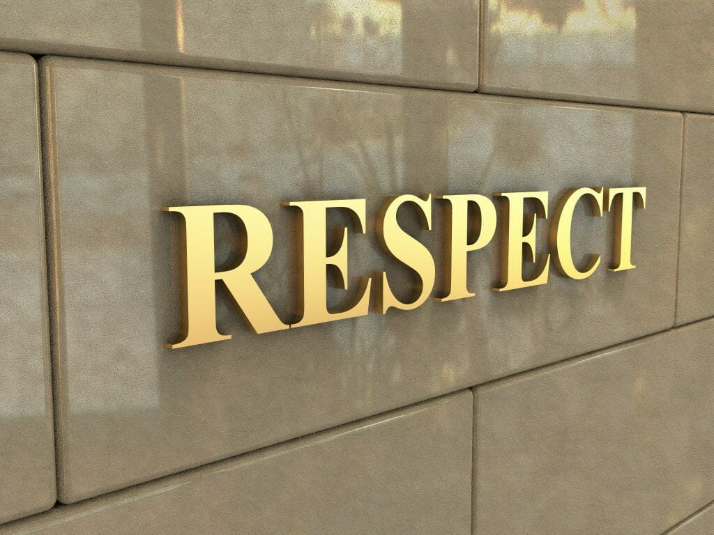 Gold letters spell "Respect" on the wall of a building