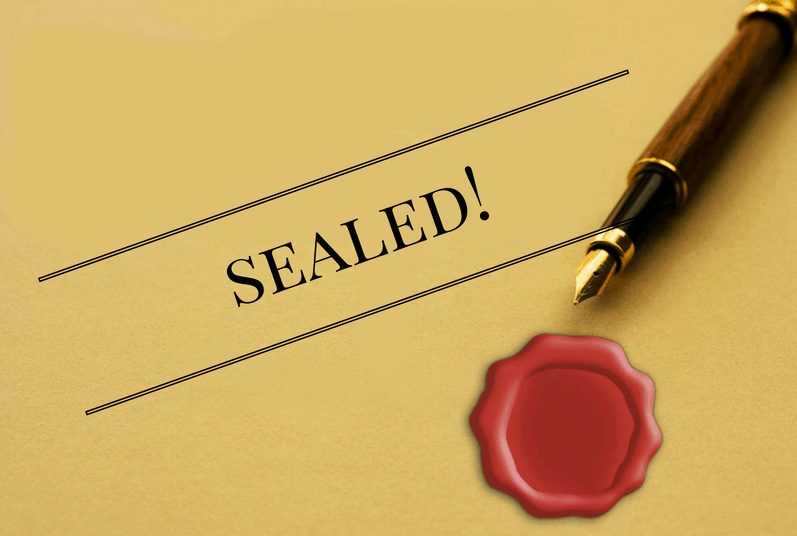The word "Sealed" on a yellow document with red sealing wax signifying sealed divorce court records