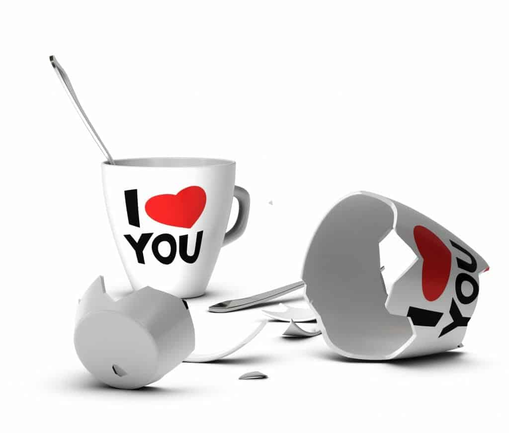 Two white cups with "I love you" on them. One is shattered, signifying domestic violence