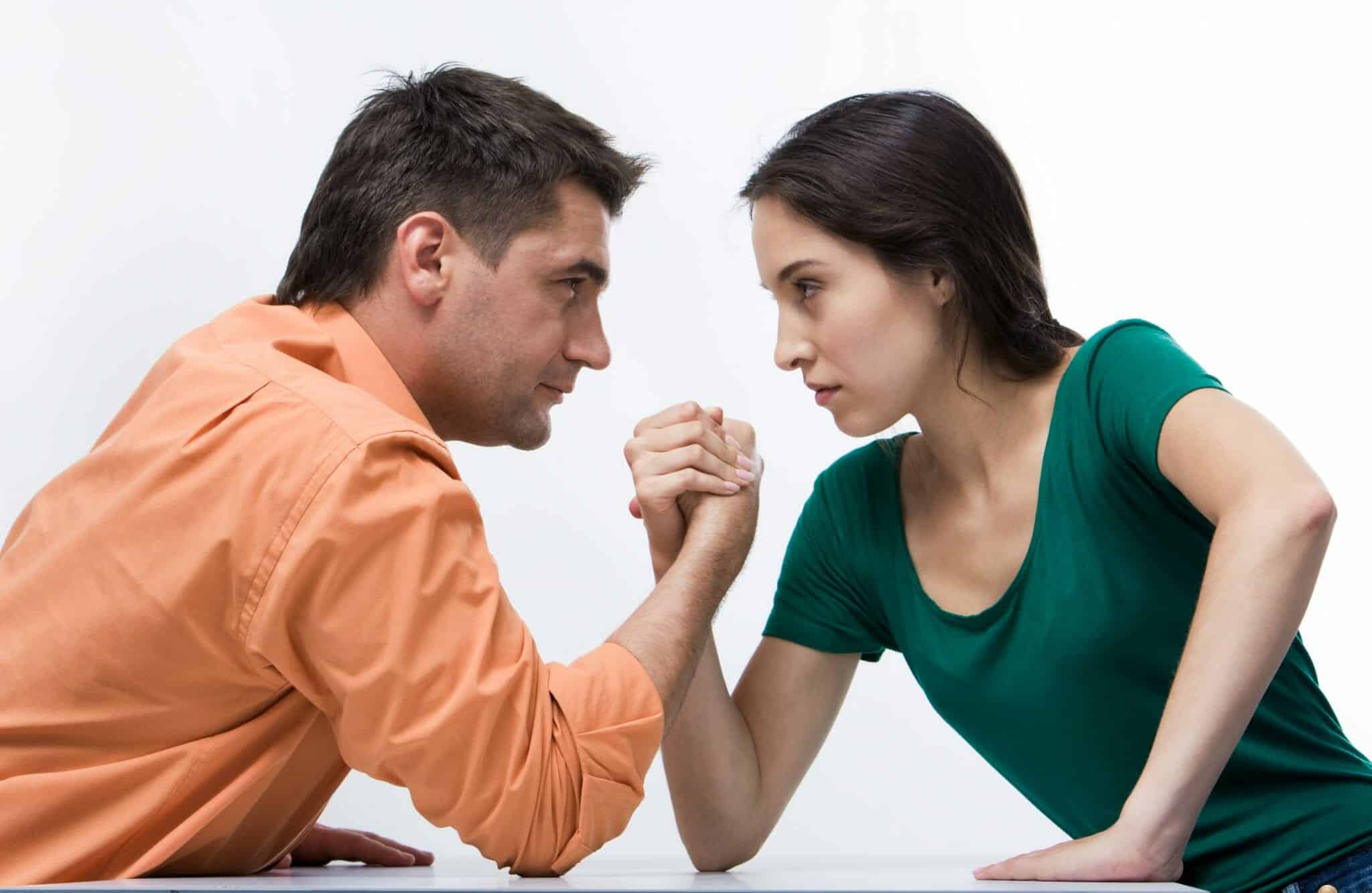 Man and woman arm wrestling - fighting with your spouse