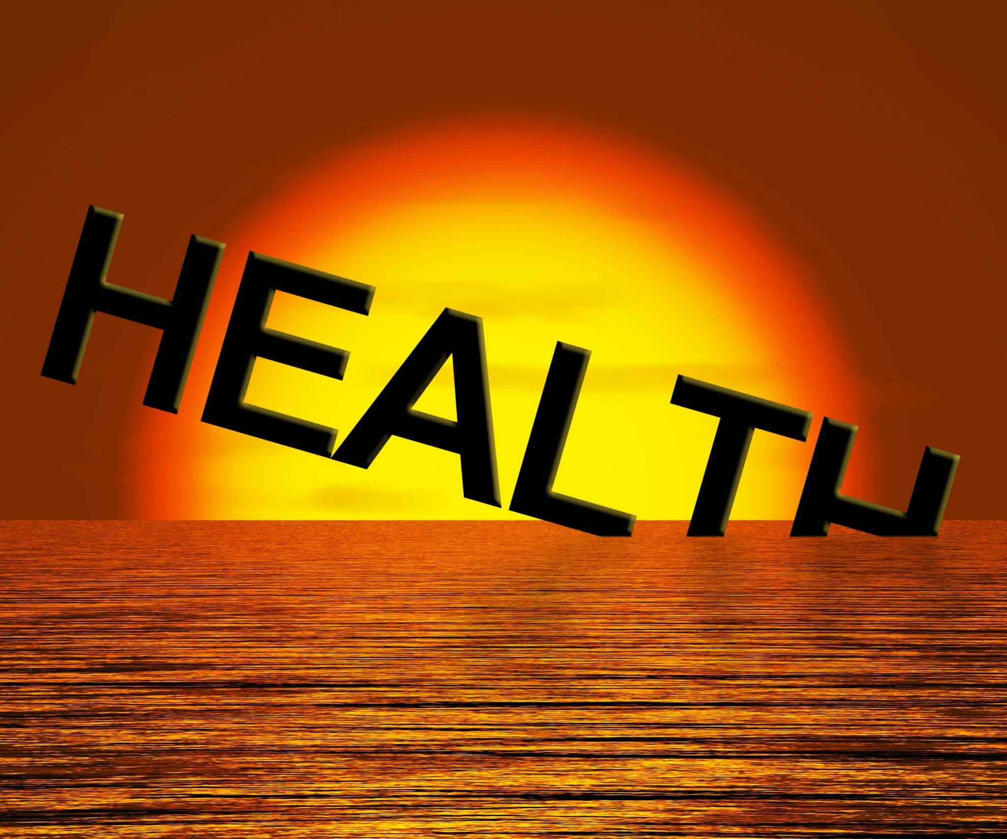 The word "Health" going down into the ocean in the sunset signifying declining health