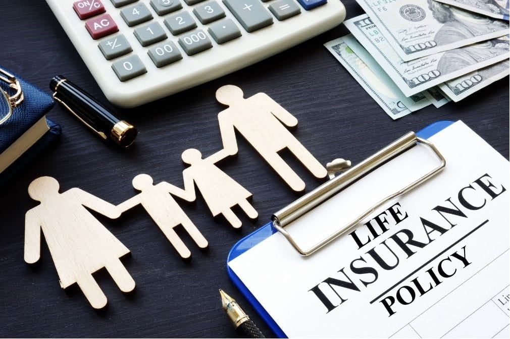 life insurance policy Life insurance policy on a table with cutout figures of a family