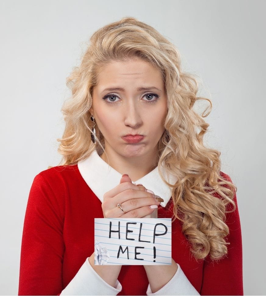 playing the victim A woman holding a "help me" sign and looking pitiful like she is the victim