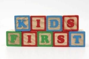 Children's blocks spell "Kids First."