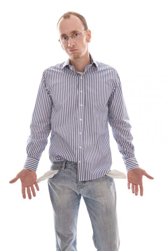 Man in jeans with empty pockets has no money to pay child support.