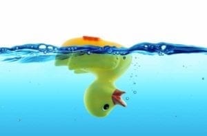 Upside down rubber duck floating in water signifying being underwater due to lack of child support payments