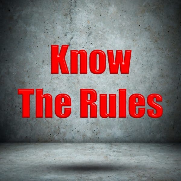 "Know the Rules" in red letters in a stark room