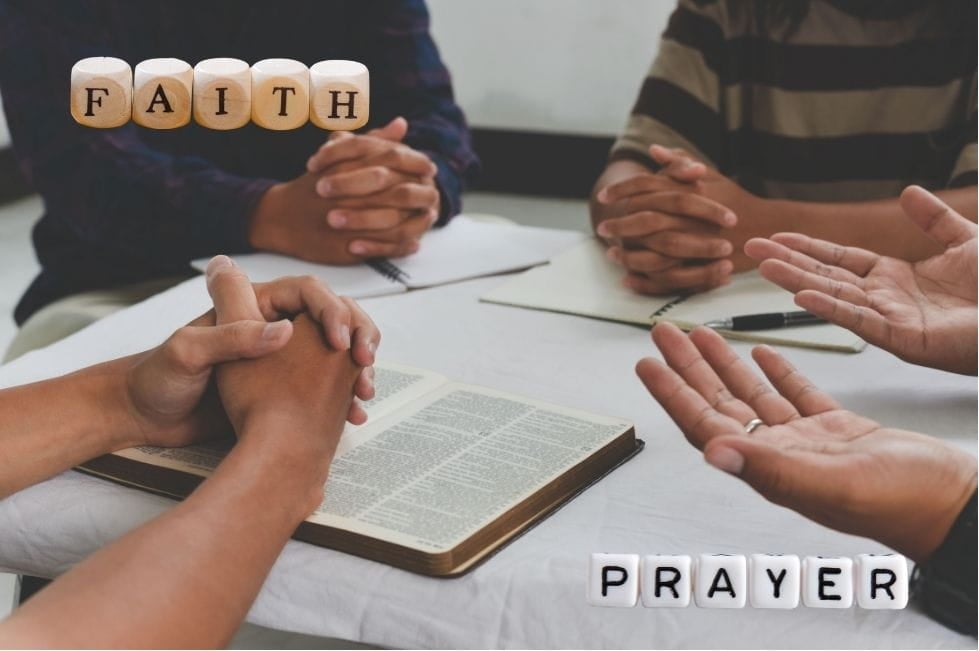 People gathered around a table in prayer. The words "faith" and "prayer" are on the image