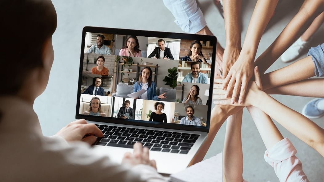 A person on an online call with multiple people. In the background of the image, hands reach towards each other symbolizing support