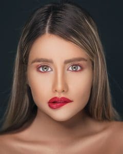 Beautiful woman biting her lip trying to give herself permission to do something.