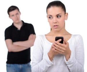 Guilty woman using cellphone while her boyfriend watchs. Affair recovery is hard.
