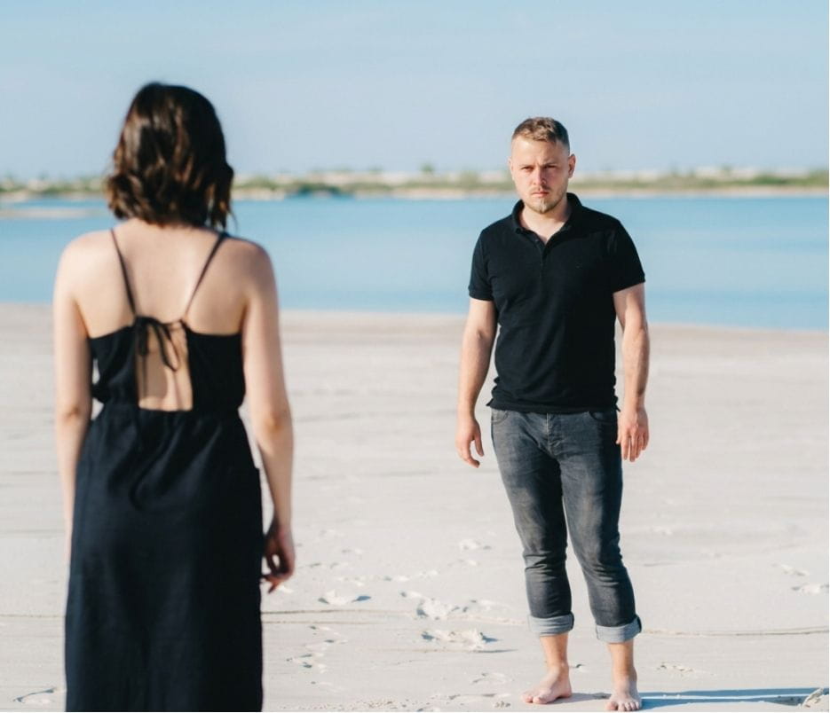 man looking sombre as he and a woman walk towards each other AI image of a man looking sombre as he and a woman walk towards each other