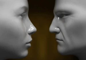 Close up of a male and female manequin, face to face. Divorce sucks!