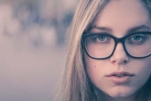 Beautiful woman with glasses wondering what to expect in a divorce.