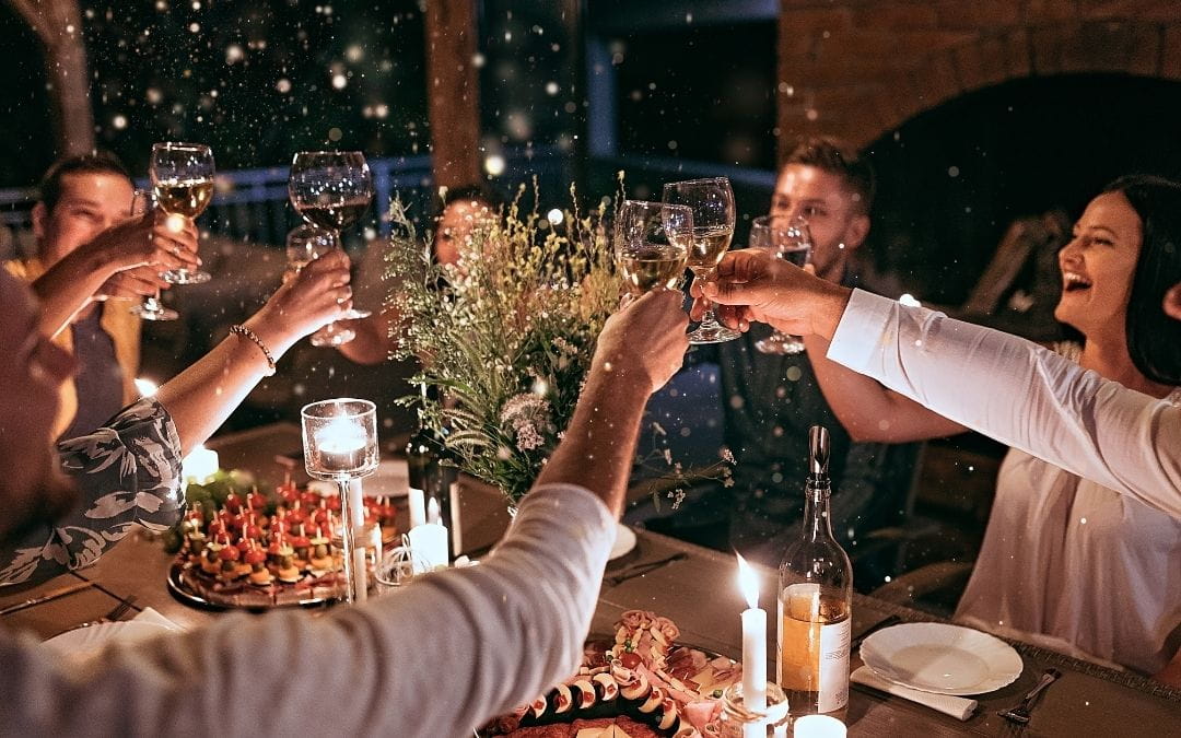 people clinking their wineglasses