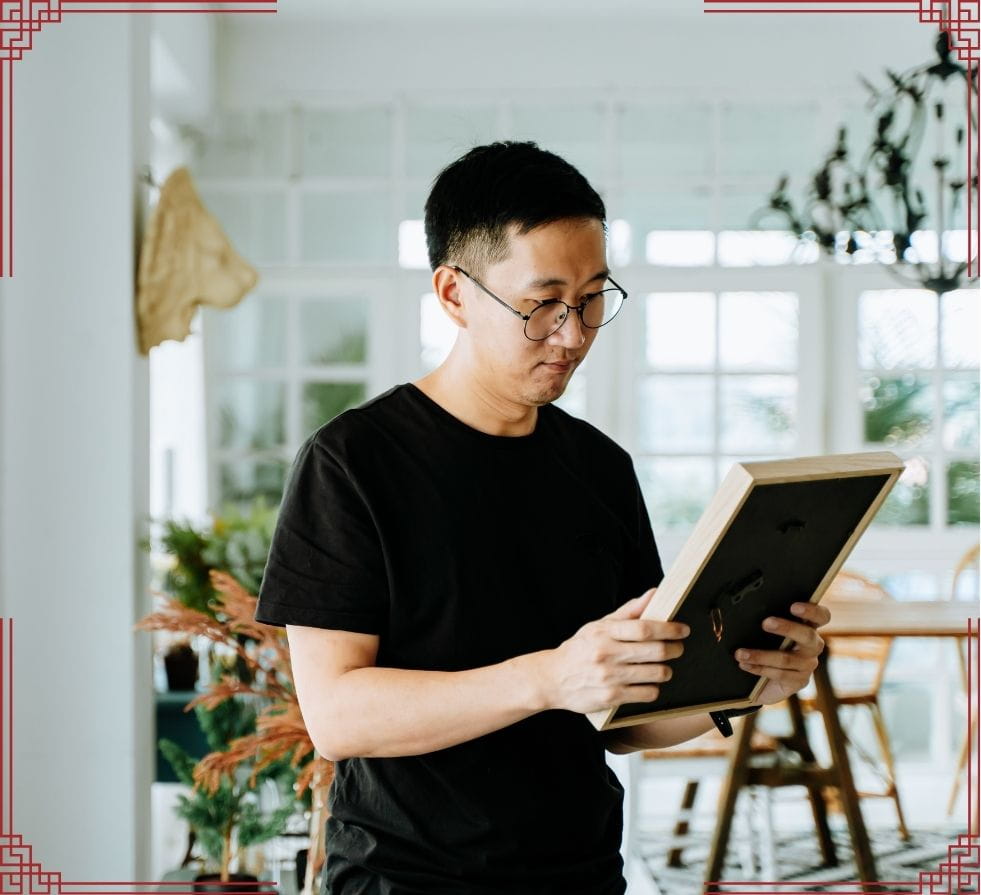 man staring deeply at a photo, he can't let go & feels a sense of loss