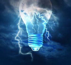 Lightbulb superimposed ona the outline of a face over a stormy sky signifying making a decision with a decision coach.